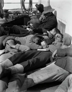A warm day in the pack. Expedition members lie in the sun on the deck of the ship Terra Nova. December 28th 1910 A warm day in the pack. Expedition members lie in the sun on the deck of the ship Terra Nova. December 28th 1910