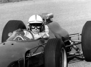 After his accident world famous auto racer John Surtees has stepped into a racing After his accident world famous auto racer John Surtees has stepped into a racing