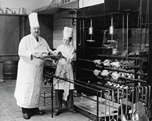 Stills Agency Gallery: A.H. Cadier, senior chef at the Brighton Pavilion is handed fake chickens by junior