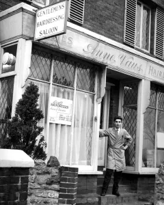 Brian Wells standing infront of his Barber Shop in London Road Westerham Kent. Twice Brian Wells standing infront of his Barber Shop in London Road Westerham Kent. Twice