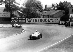 Stirling Gallery: British racing driver Stirling Moss No 12, takes the lead from Fangio of Argentina