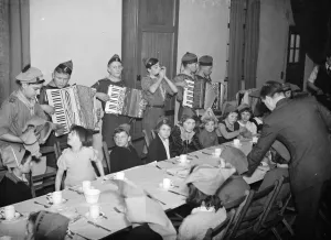 Children being entertained by an accordian band while they have their Christmas breakfast Children being entertained by an accordian band while they have their Christmas breakfast