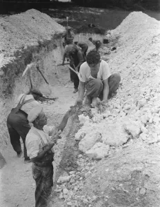 Digging a trench in search for skeletal remains in Horton Kirby, Kent Digging a trench in search for skeletal remains in Horton Kirby, Kent