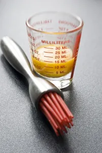 Egg yolk in small glass measuring glass with modern pastry brush with red silicone bristles
credit: Marie-Louise Avery / thePictureKitchen / TopFoto Egg yolk in small glass measuring glass with modern pastry brush with red silicone