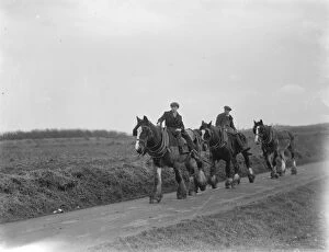Farm workers returning home on their horses after a day s ploughing