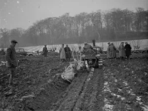 Farmers watch a ploughing demonstration with the new Melotte tractor