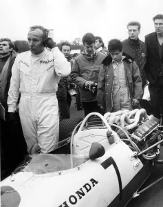 John Surtees leaving his honda after retiring with engine trouble during the Race John Surtees leaving his honda after retiring with engine trouble during the Race