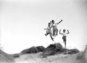 Images Dated 27th August 2015: Jumping for joy at Camber Sands in Sussex. 1934