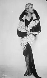 Lili Damita, wearing the magnificent silver brocade coat presented by Jenny. 24