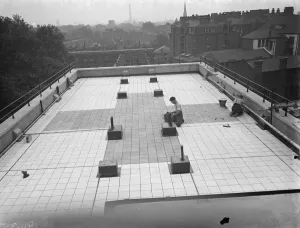 Prints of Workers from Val De Travers Asphalt Limited, a paving company, working on paving the roof of the London Jewish Hospital in Stepney Green. 1938 Hospital Prints: Print of Workers on London Jewish Hospital Roof Paving, 1938