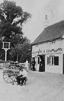 Stock Agency Gallery: A man with a small cart outside public house at Eversley 1906