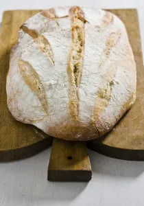 Organic rustic white loaf on wooden cutting board credit: Marie-Louise Avery / Organic rustic white loaf on wooden cutting board credit: Marie-Louise Avery /