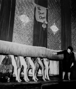 Prints of Windmill Theatre Owner Miss Sheila Van Dam watches as the curtain comes down over the legs of the Windmill Girl Dancers for the last time today as the era of the famous Windmill Theatre London comes Theatre Prints: Windmill Theatre Print: A Colour Photograph of a Dancer's Legs