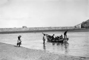 People out fishing from a Coble ( a locally made fishing boat ) at low tide, near People out fishing from a Coble ( a locally made fishing boat ) at low tide, near