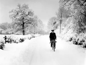 Postman cycling through snow in Bough Beech, Kent. 28th December 1962 Postman cycling through snow in Bough Beech, Kent. 28th December 1962