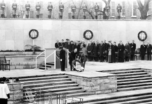 President Eamonn de Valera of Eire ( hatless ) assisted by a uniformed man lays a President Eamonn de Valera of Eire ( hatless ) assisted by a uniformed man lays a