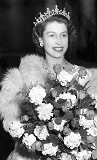 Princess Elizabeth wearing a tiara and carrying a bouquet of flowers at Warner Theatre