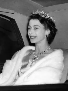 Prints of Queen Elizabeth II jewels glittering in her hair and at her throat arrives at Swedish Embassy in Portland Palace London to attend the State Banquet 29 June 1954 Related Prints: Queen Elizabeth II in jewels print, 29 June 1954
