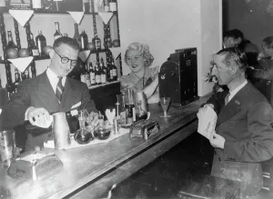 Stravinsky's secretary now runs cocktail bar with London dancer as hostess.
Gilbert Ramognie, former secretary of Serge Stravinsky, the French Swindler, has now opened a cocktail bar called Merry go Round, in the Rue de Berri just off the Champs Elysees, Paris. Romaginno was acquitted on charges of receiving stolen money after spending 23 months in prison.
The hostess of the new bar is Madame Romagnino, the former Celia Nano, London dancer who was questioned by Scotland Yard officials in connection with the Stravinsky's case.
The doorman of the bar is Henry Voix who was Staviskys companion at the Stravinsky case.
Photo shows, left-to-right, Gilbert Romagnino, Madame Romagnino, and Henry Voix at the new bar.
19 September 1936 Stravinskys secretary now runs cocktail bar with London dancer as hostess. Gilbert Ramognie