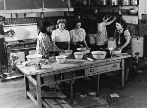 Stock Agency Gallery: Teaching young women cooking in a kitchen 1950s