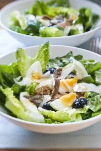 White bowl of classic Salade Nicoise, with vinaigrette credit: Marie-Louise Avery White bowl of classic Salade Nicoise, with vinaigrette credit: Marie-Louise Avery