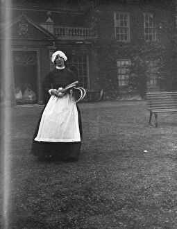 A woman in a servant s period dress at Lullingstone Park near Eynsford, Kent