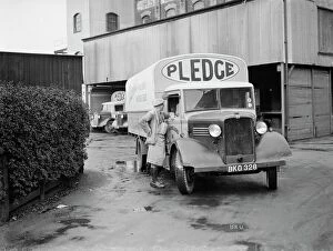 Lorry Gallery: A worker chats to the driver of a loaded Bedford truck belonging to Pledge & Son Ltd
