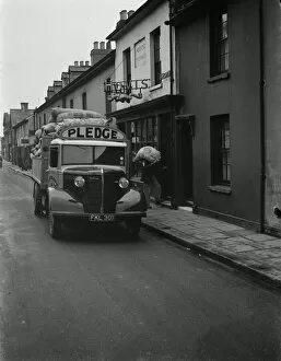 Lorry Gallery: Workers are unloading sacks of flour from a Bedford truck belonging to Pledge & Son Ltd