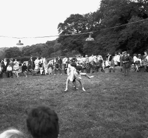 A crowd of people gathered to watch a Cornish wrestling match at an unknown location, Cornwall. 1970 A crowd of people gathered to watch a Cornish wrestling match at an unknown location, Cornwall. 1970