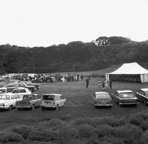 A crowd of people gathering to watch a Cornish wrestling match at an unknown location, Cornwall. 1970 A crowd of people gathering to watch a Cornish wrestling match at an unknown location, Cornwall. 1970