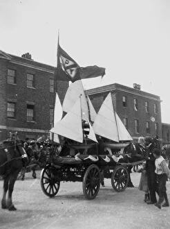 Images Dated 18th July 2019: Model yachts being carted in procession through town, Newquay, Cornwall. Early 1900s