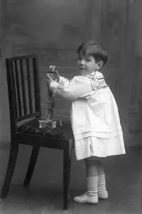 Prints of Studio portrait photograph of Alan Tindal Lennox-Boyd as a young boy playing with building blocks on a chair Bedfordshire Prints: Studio portrait print of a young boy playing with building blocks