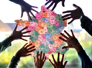 Hands Surrounding Map of France Hands Surrounding Map of France