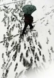 Images Dated 6th March 2006: A man walks with his umbrella under snow in downtown Belgrade, 06 March 2006
