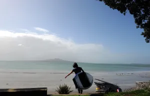 <b class=qtipBold><figcaption>New Zealand-Surfing-Feature</figcaption></b><br>A man carries a board in Takapuna Beach, north of Auckland. AFP PHOTO / FRANCK FIFE / AFP PHOTO / FRANCK FIFE<br><em>© Copyright Agence France-Presse (AFP) - All Rights Reserved</em> New Zealand-Surfing-Feature