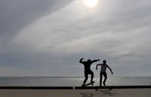 People ride a skateboard along the beach on October 7, 2016 in Saint-Nazaire, western France People ride a skateboard along the beach on October 7, 2016 in Saint-Nazaire, western France