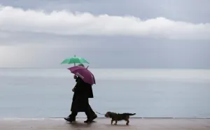 People walk on the Promenade des Anglais during a rainy afternoon, on November 25 People walk on the Promenade des Anglais during a rainy afternoon, on November 25