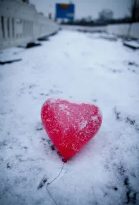 A red heart-shaped balloon lays in the snow on Februray 14, 2012 in Frankfurt/M A red heart-shaped balloon lays in the snow on Februray 14, 2012 in Frankfurt/M