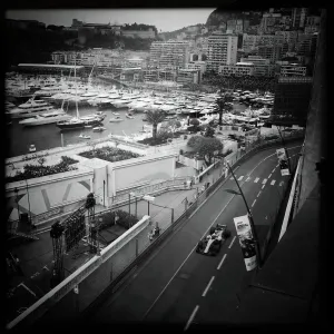 Prints of Picture taken with a mobile phone shows F1 pilots driving along the yacht marina during Monaco Formula 1 Grand Prix at the Monaco street circuit on May 27, 2018 in Monaco. / AFP PHOTO / VALERY HACHE Monaco Prints: Monaco F1 Pilots Print