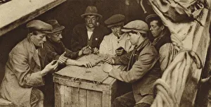 Bargee and his mates playing dominoes in the hold of a barge on a London canal (b/w photo Bargee and his mates playing dominoes in the hold of a barge on a London canal (b/w photo