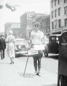 Occupations Gallery: Blind World War I Veteran Selling Newspapers on Sidewalk, Washington DC, USA, 1933 (b/w photo)
