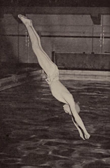Boy diving into a swimming pool (b / w photo)