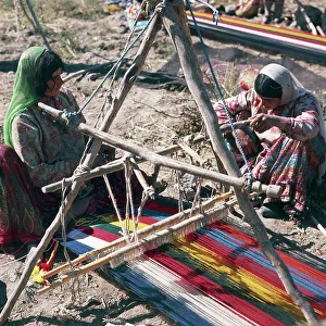 Boyer Ahmadi tribeswomen weaving on horizontal loom, Qashqai people, Zohreh River valley Boyer Ahmadi tribeswomen weaving on horizontal loom, Qashqai people, Zohreh River valley