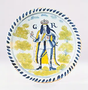A Bristol Delft polychrome royal portrait charger painted with a full length portrait of A Bristol Delft polychrome royal portrait charger painted with a full length portrait of