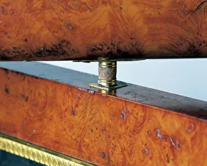 Bronze pivot from tilting mirror on an Empire style oak dressing table with ash veneer Bronze pivot from tilting mirror on an Empire style oak dressing table with ash veneer