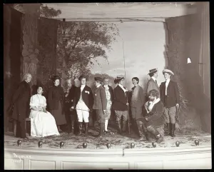 The cast on stage in costume from an amateur production of a play titled ' The cast on stage in costume from an amateur production of a play titled '