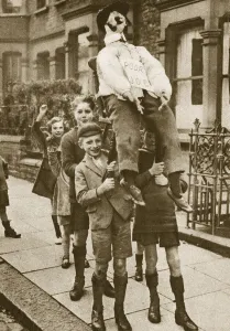Children carrying a Guy Fawkes on Bonfire Night (sepia photo) Children carrying a Guy Fawkes on Bonfire Night (sepia photo)