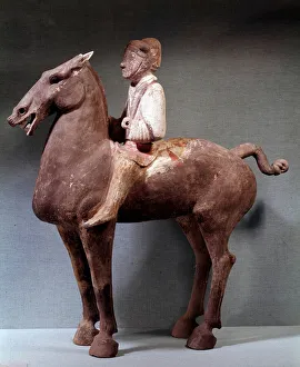 Chinese art: funerary statuette representing a cavalier in terracotta Chinese art: funerary statuette representing a cavalier in terracotta
