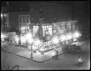 Second Avenue Gallery: Cohens clothing store with illuminated display windows, Second Avenue and 7th Street