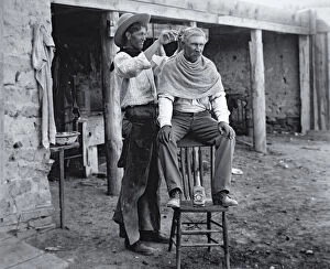 Norman Mills (after) Price Gallery: Cowboy having haircut, c.1905 (b / w photo)